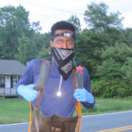 Man in full-body protection and headlamp at evening