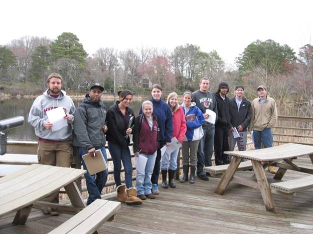 A group of people standing on a deck

Description automatically generated with low confidence