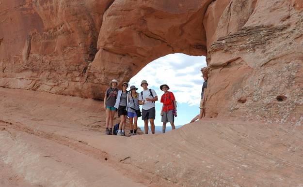 A group of people standing in a cave

Description automatically generated with medium confidence